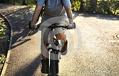 Senior woman biking in the park Stock Photo