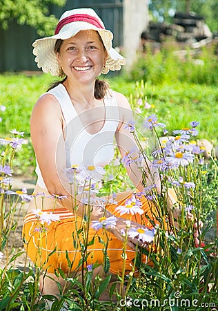Senior woman with blue camomile Stock Photo