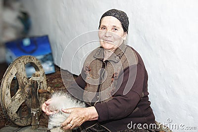 Senior woman carding woollen yarn Stock Photo