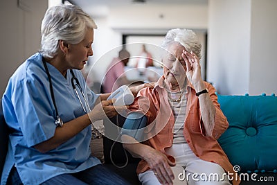 Senior woman complaining about headache to doctor Stock Photo