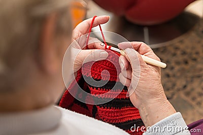 Senior woman with a crochet needle and wool Stock Photo