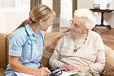 Senior Woman In Discussion With Health Visitor Stock Photo