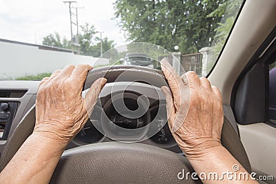 Senior woman driving a car in town Stock Photo