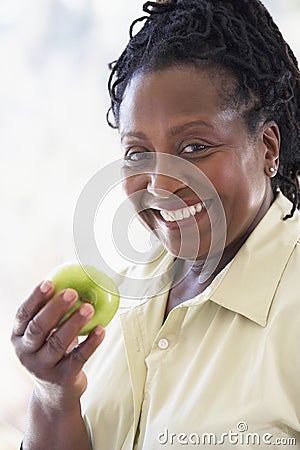 Senior Woman Eating Green Apple Stock Photo