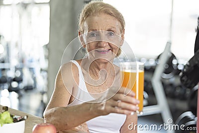 Senior woman eating healthy salad and orange juice. elderly health lifestyle nutrition concept Stock Photo