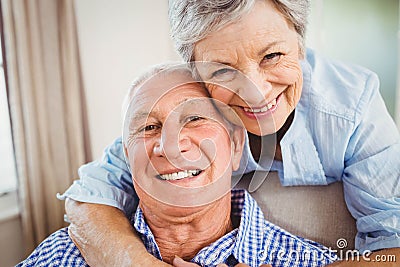 Senior woman embracing man at home Stock Photo