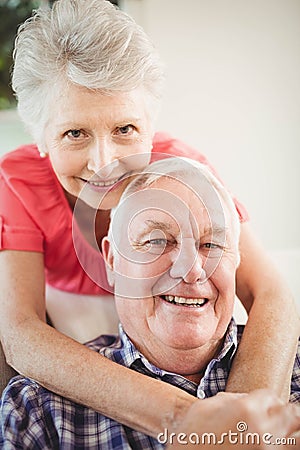 Senior woman embracing man at home Stock Photo