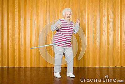 Senior woman exercising with a hula hoop Stock Photo