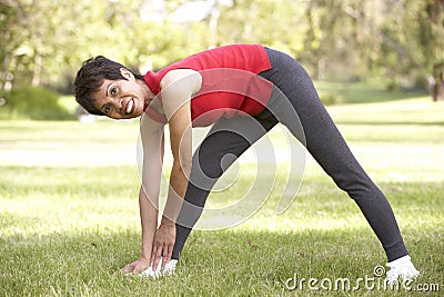 Senior Woman Exercising In Park Stock Photo