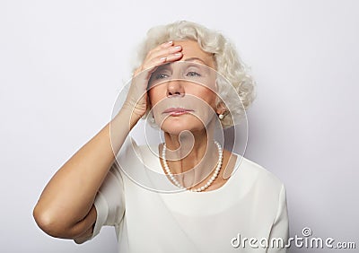 Senior woman feeling blue worried about problems, pensive upset sad middle aged grey haired lady Stock Photo