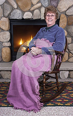 Senior Woman Grandma Rocking Chair Fireplace Stock Photo