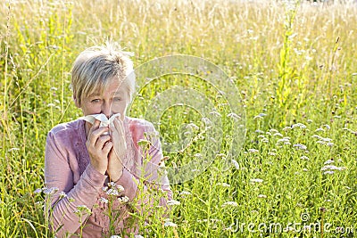 Senior woman with handkerchief in the grass Stock Photo