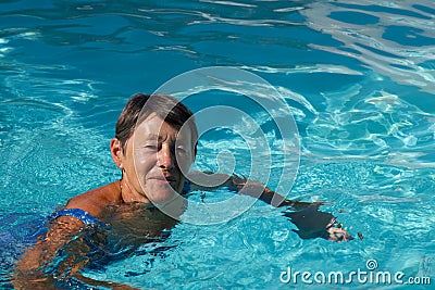 Senior woman happy in the swimming pool Stock Photo