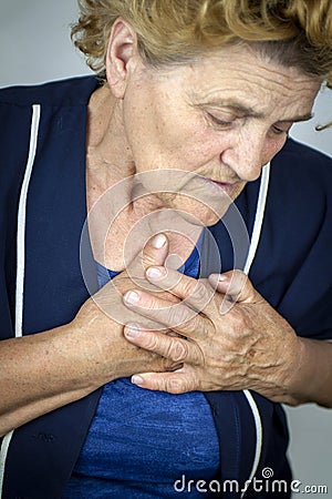 Senior woman having chest pain Stock Photo