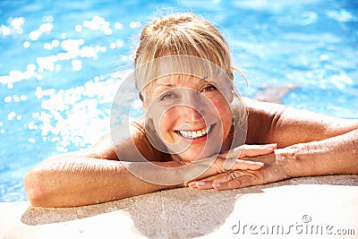 Senior Woman Having Fun In Swimming Pool Stock Photo