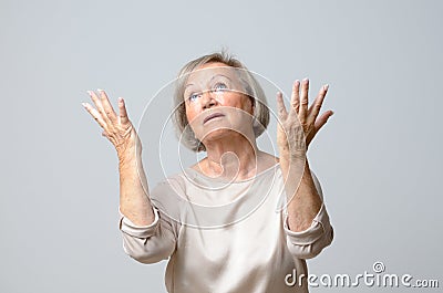 Senior woman with her hands up to the sky Stock Photo