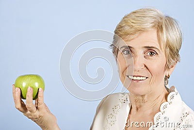 Senior woman holding and apple Stock Photo