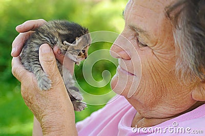Senior woman holding little cat Stock Photo