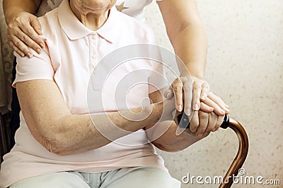 Close up of mature womans & nurse hands. Health care giving, nursing home. Parental love of grandmother. Old age related diseases. Stock Photo