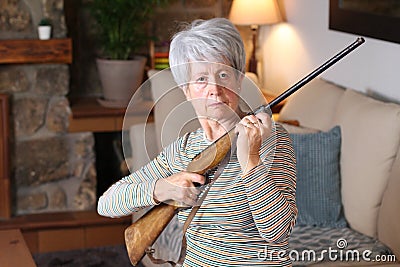 Senior woman holding a rifle Stock Photo