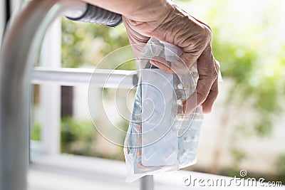 Senior woman is holding several packs of medicine in her hand,elderly have a lot of drugs,pills,capsules in a zip bag,medication Stock Photo