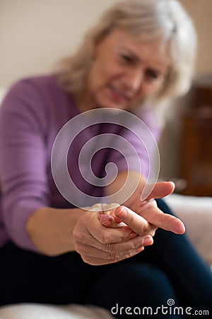 Senior Woman At Home In Pain Suffering With Arthritis Stock Photo