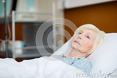 Senior woman in hospital bed Stock Photo