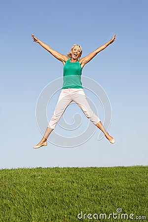 Senior woman jumping in air Stock Photo