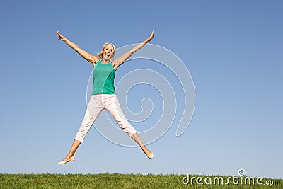 Senior woman jumping in air Stock Photo