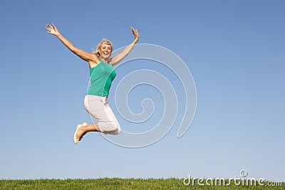 Senior woman jumping in air Stock Photo