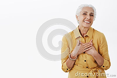 Senior woman keep getting compliments looking fresh and beautiful. Delighted happy charming old lady with white hair in Stock Photo