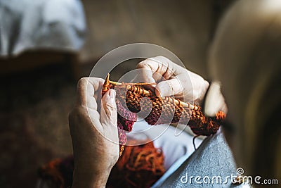 Senior woman knitting for hobby at home Stock Photo