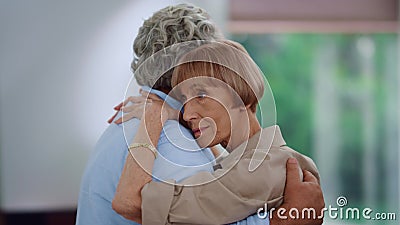 Senior woman and man enjoying slow dance. Wife hugging husband during dance Stock Photo