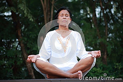 Senior woman meditation on the quiet park Stock Photo