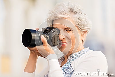 Senior woman photographing by digital camera Stock Photo