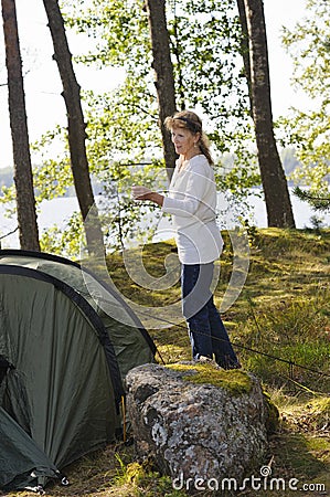 Senior woman pitching a tent Stock Photo