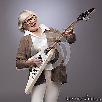 Senior woman playing electric guitar Stock Photo