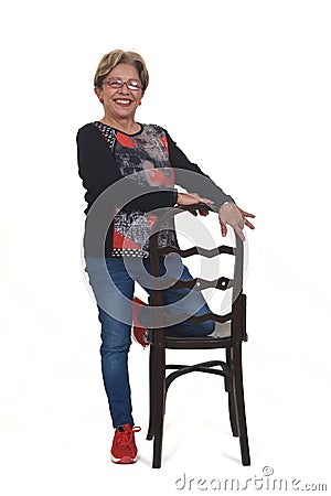 Senior woman playing wiyh chair on white Stock Photo