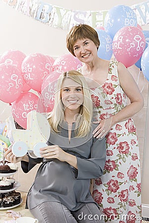 Senior Woman And Pregnant Daughter At A Baby Shower Stock Photo
