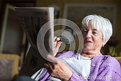 Senior woman reading morning newspaper Stock Photo
