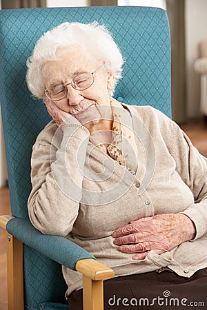 Senior Woman Resting In Chair Stock Photo