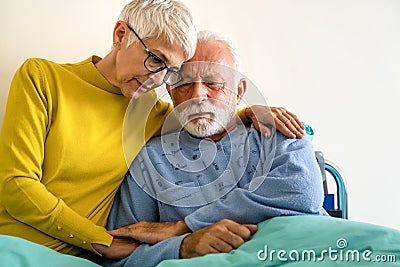 Senior woman with seriously ill husband in hospital. Healthcare support anxiety love concept Stock Photo