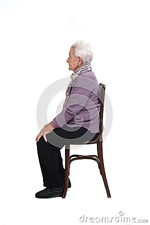Senior woman sitting on white background Stock Photo