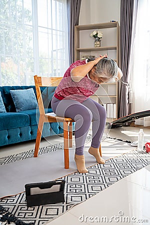 Senior woman stretch back muscles for exercise at home Stock Photo