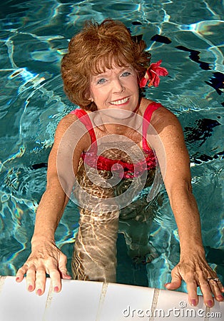 Senior woman stretching in the pool Stock Photo