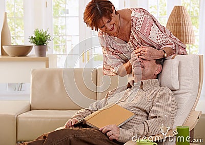 Senior woman surprising her husband Stock Photo