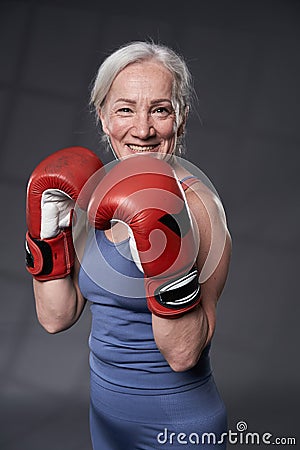Senior woman taking boxing lessons Stock Photo