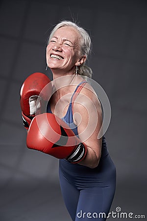 Senior woman taking boxing lessons Stock Photo