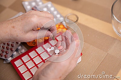 Senior Woman Taking Prescription Medicine and Organizing Pill Box Stock Photo