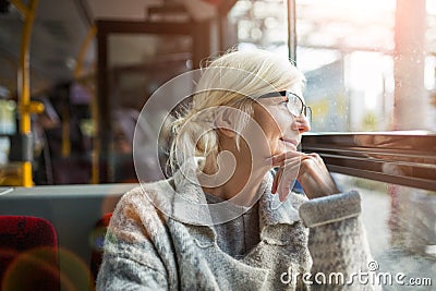 Senior Woman Traveling In Bus Stock Photo